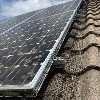 Solar panel bird-proofing mesh installation on a tiled roof — S Quinlan Roofing, Warwickshire
