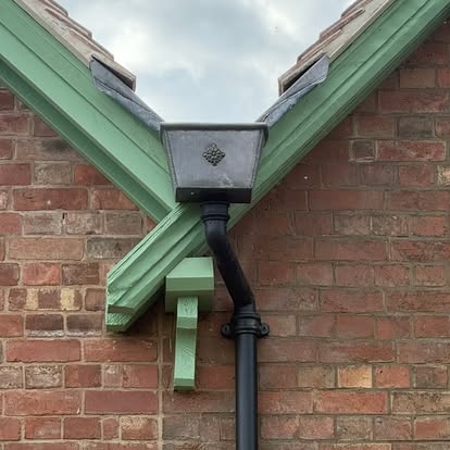 Cast-style hopper head and downpipe installed on a period property — S Quinlan Roofing, Leamington Spa